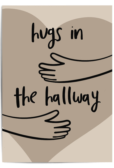 Neutral-toned wall art print leaning against a wooden door in a cozy hallway, featuring minimalist line art of arms and the phrase 'Hugs in the Hallway' over a heart shape