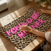 Pink leopard print wall art with bold typography reading “I Could Be Meaner”, displayed in a modern glam interior.