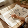floral line art on a piece of paper with a soft focus beige ackground