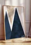 Framed abstract art piece with geometric design on a wall.