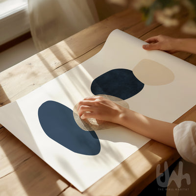 Abstract wall art print with navy, beige, and textured cream circular shapes stacked like stepping stones, styled in a modern interior space.