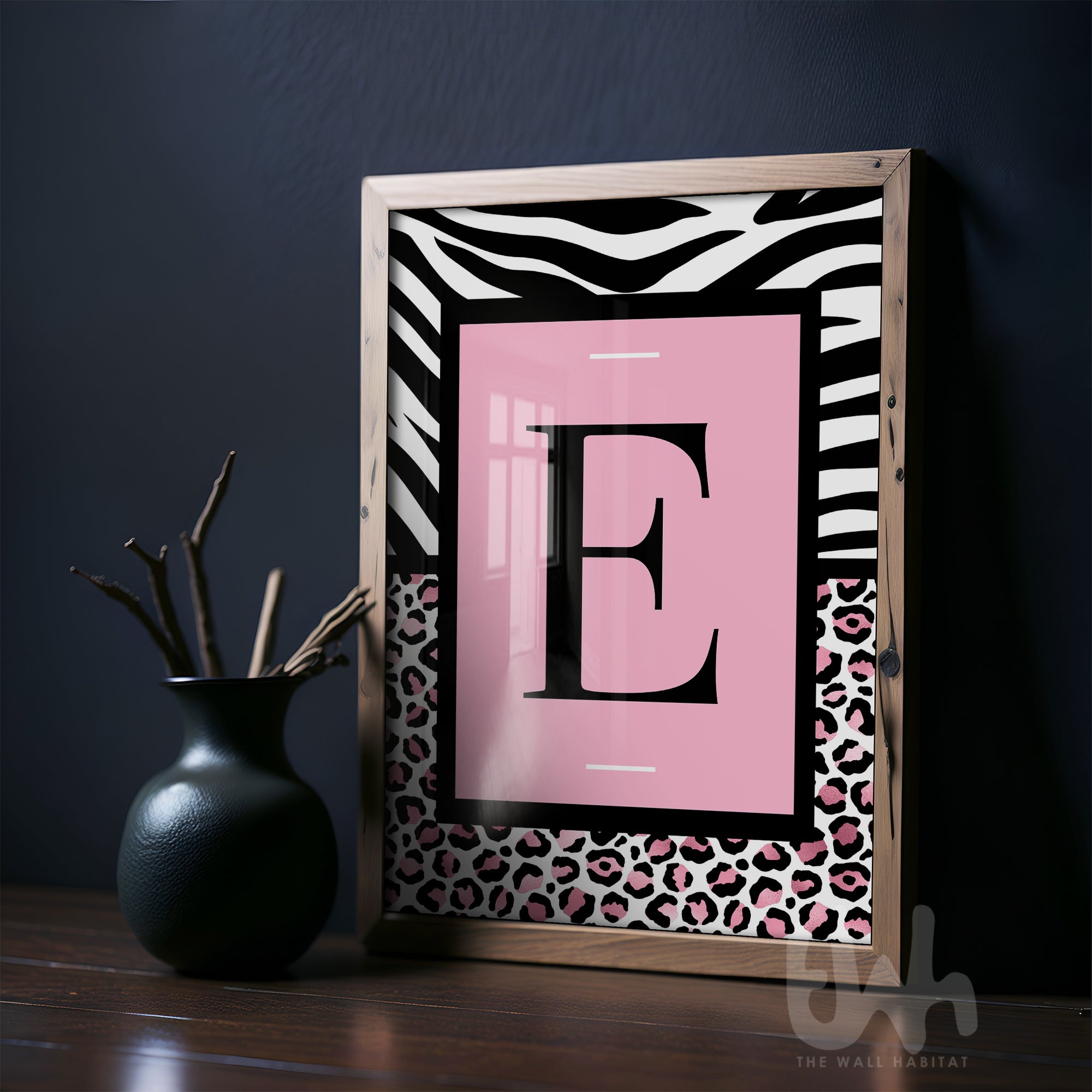 Personalised pink leopard initial wall art with zebra print border displayed in a modern interior setting