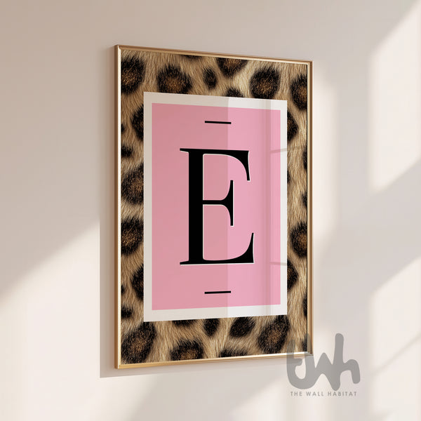 Personalised pink leopard initial wall art print featuring a bold letter on a blush background in a gold frame.