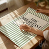 Green and white striped print with 'The Breakfast Club' text on a wooden table.