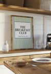 Wooden shelf with a framed sign reading 'The Breakfast Club' in a kitchen setting.