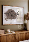 Decorative wall art with a tree and text on a plaid background, displayed on a wooden shelf.