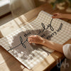 print with tree design and text on a wooden table