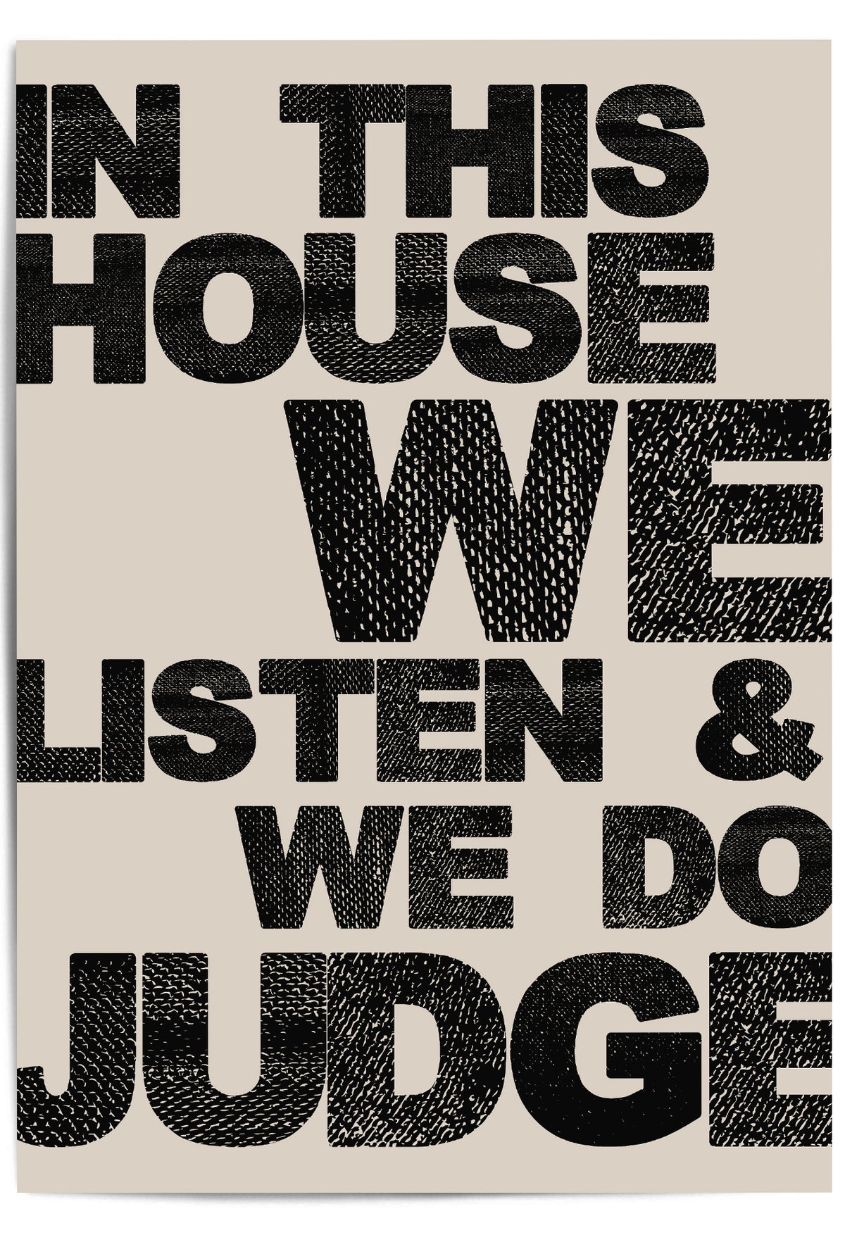 Close-up of "In This House We Listen & We Do Judge" bold typographic wall art on neutral background